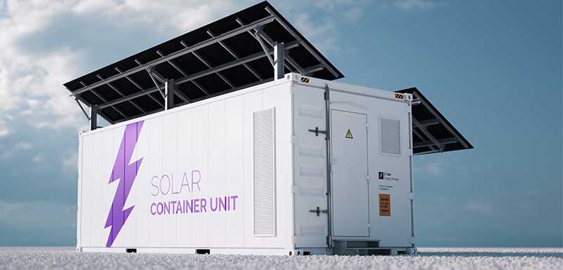 Image of a solar container unit supporting solar panels with a blue sky and clouds in the background. The unit houses utility-scale central inverters. These grid-tied photovoltaic inverters directly connect solar systems to the power grid.